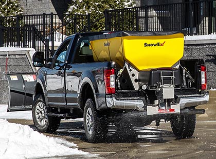 large salt spreader in bed of truck